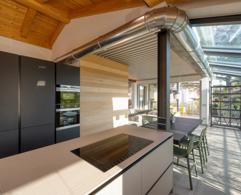 cucina open space con materiali materici, legno e metallo a vista